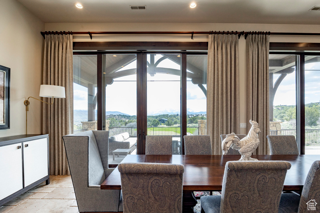 Dining area with recessed lighting, a mountain view, visible vents, and stone tile flooring
