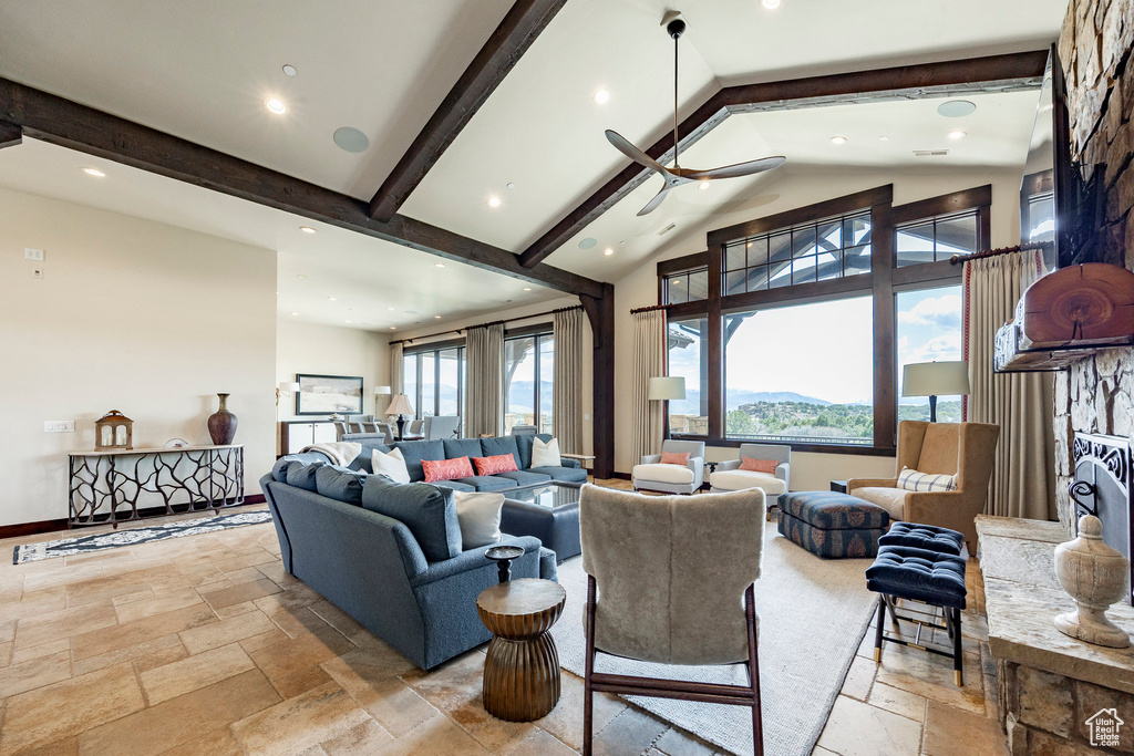 Living area with recessed lighting, beamed ceiling, high vaulted ceiling, and stone tile flooring