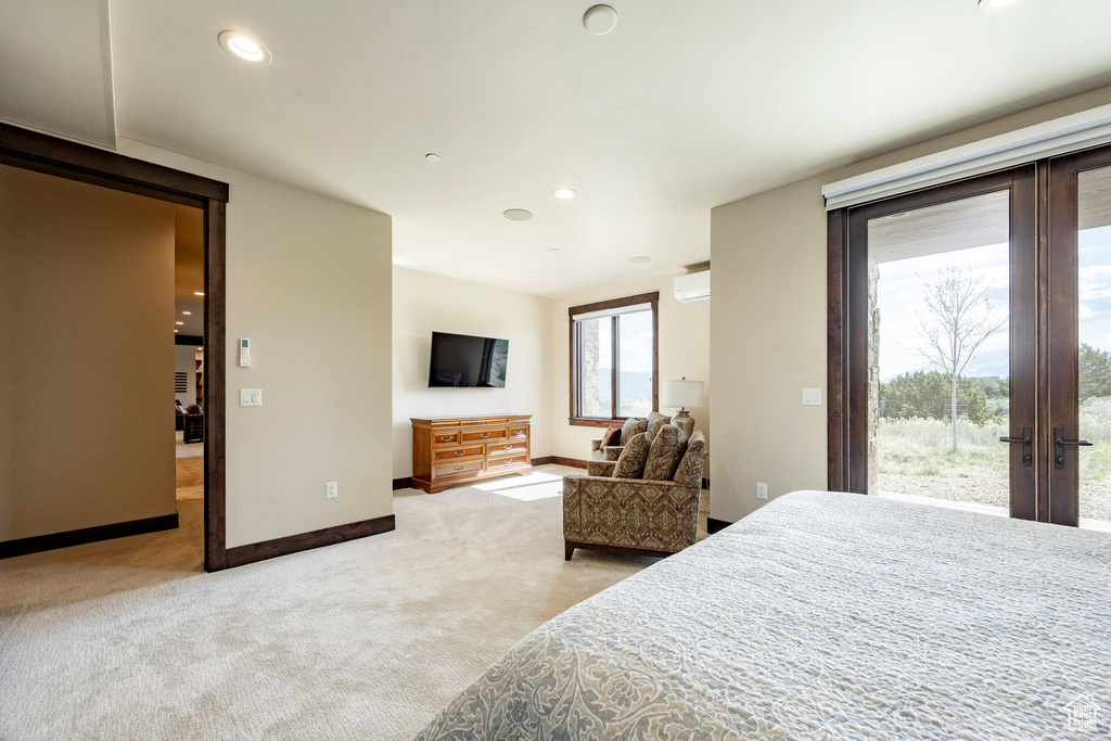 Carpeted bedroom featuring a wall mounted air conditioner, french doors, recessed lighting, baseboards, and access to exterior
