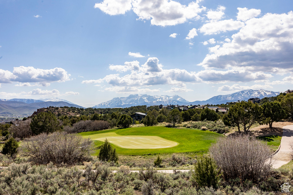 View of home's community with a mountain view and view of golf course