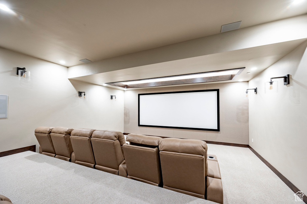 Cinema room with carpet floors and baseboards