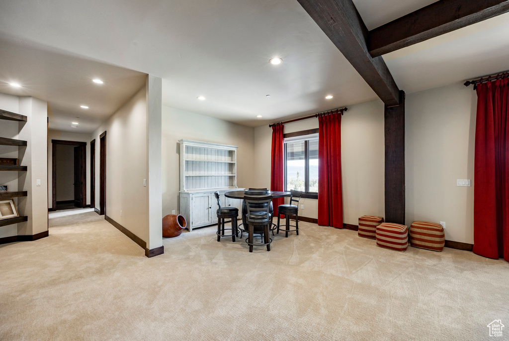Dining room with light colored carpet, baseboards, and recessed lighting
