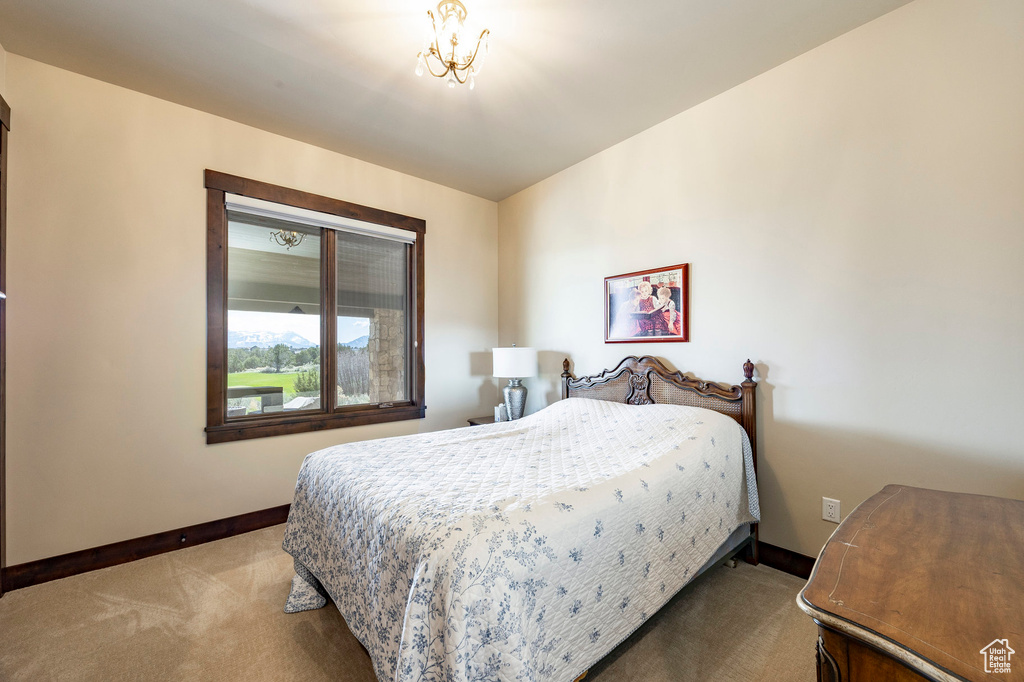 Bedroom featuring carpet and baseboards