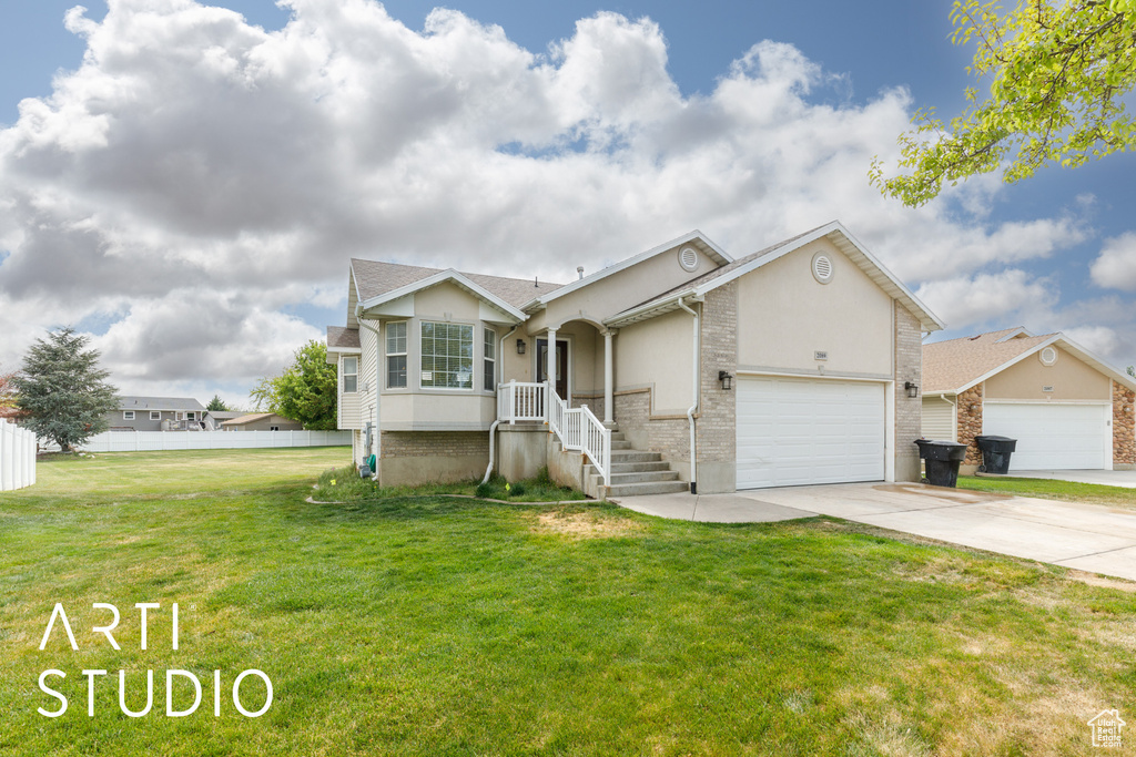 Single story home featuring concrete driveway, stucco siding, a front lawn, and a garage