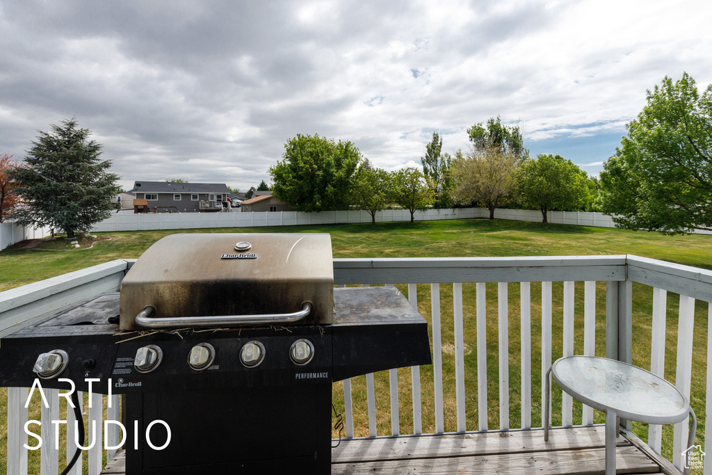 Deck with a yard, grilling area, and fence