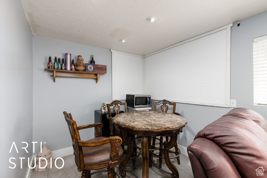 Tiled dining area featuring baseboards