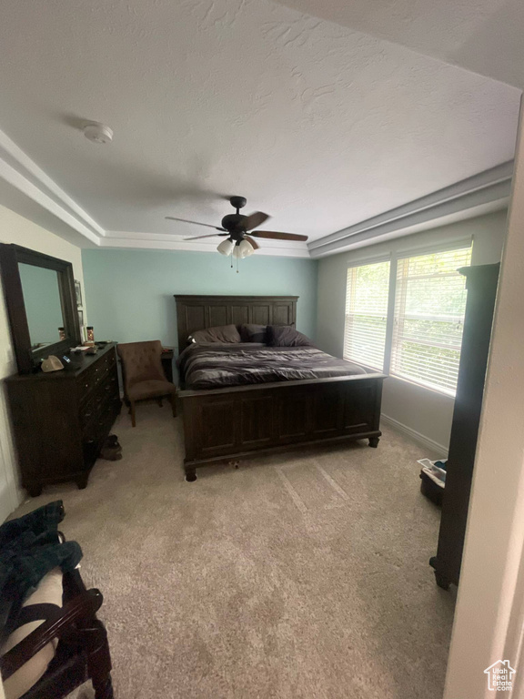 Carpeted bedroom featuring ceiling fan