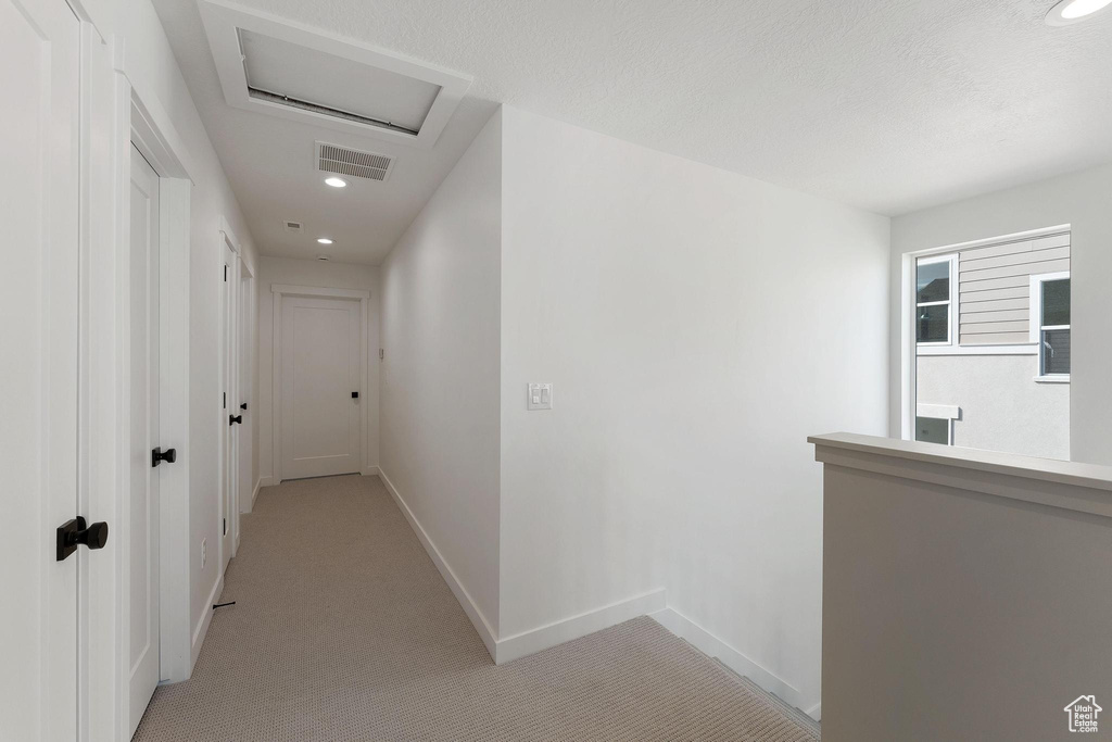 Hall featuring light colored carpet, visible vents, baseboards, and recessed lighting