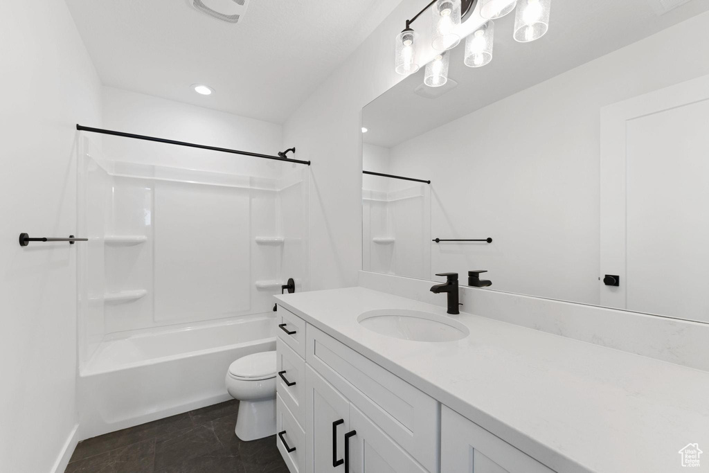 Full bath featuring toilet, baseboards, shower / tub combination, tile patterned flooring, and vanity