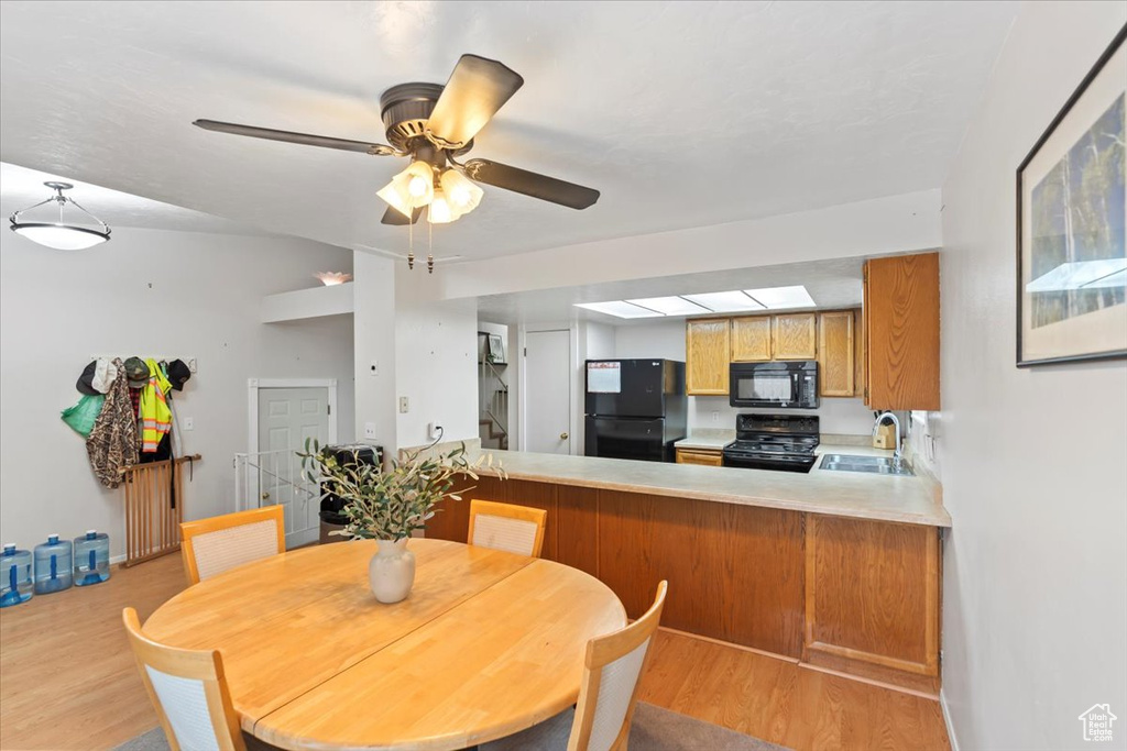 Dining area with light wood-style flooring and ceiling fan