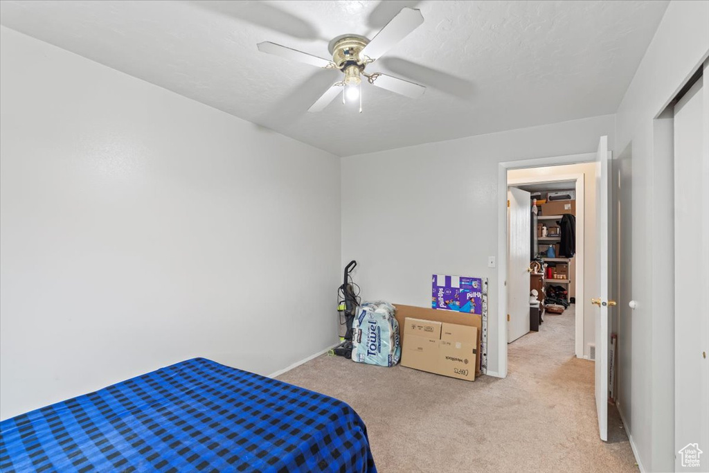 Bedroom featuring ceiling fan and light carpet