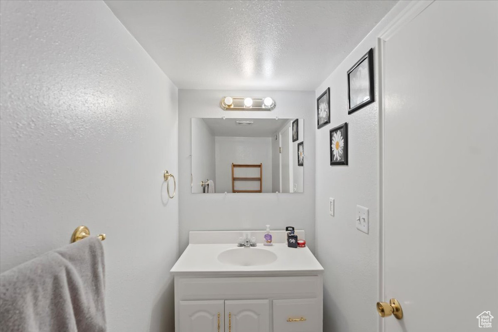 Bathroom with vanity and a textured ceiling
