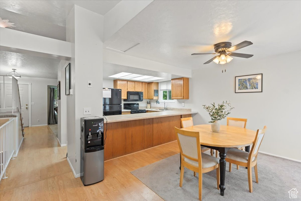Dining space featuring light wood-type flooring, baseboards, and ceiling fan