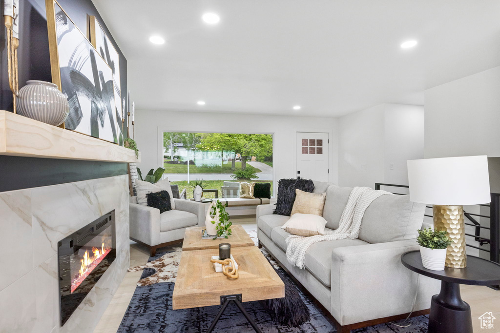 Living area with a high end fireplace and recessed lighting