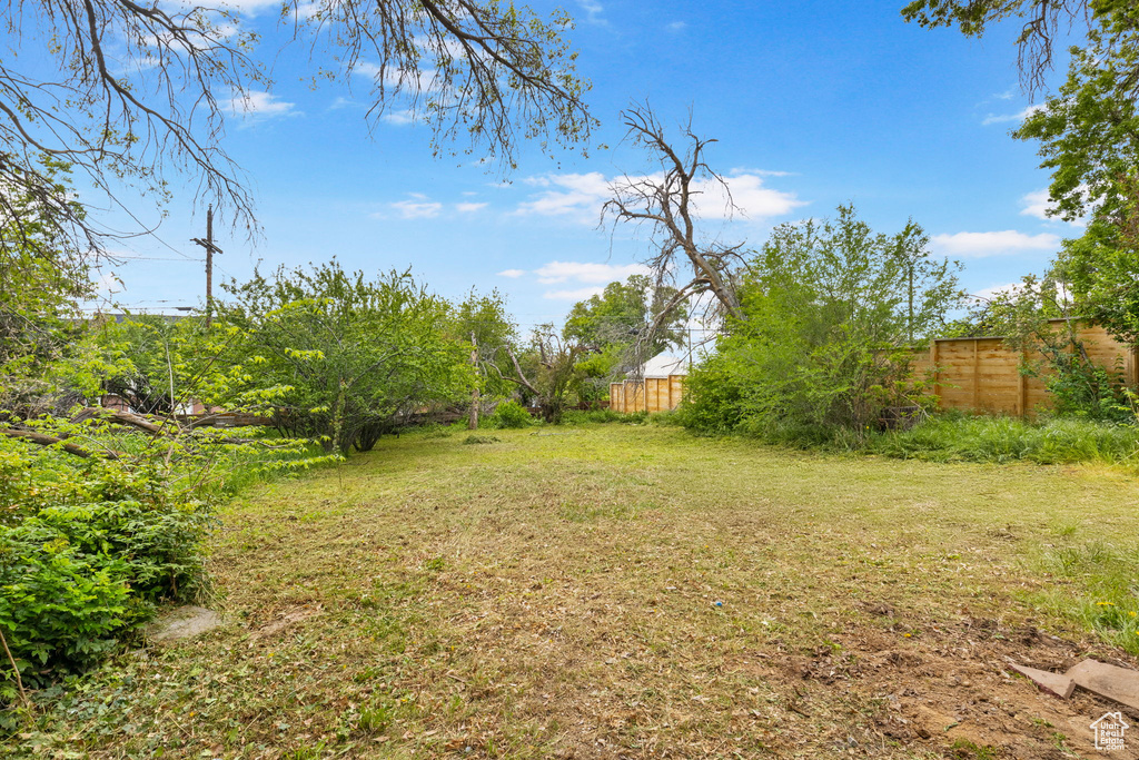 View of yard featuring fence