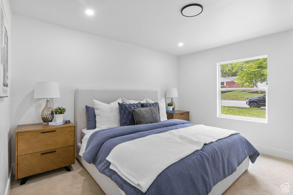 Bedroom featuring light carpet, baseboards, and recessed lighting