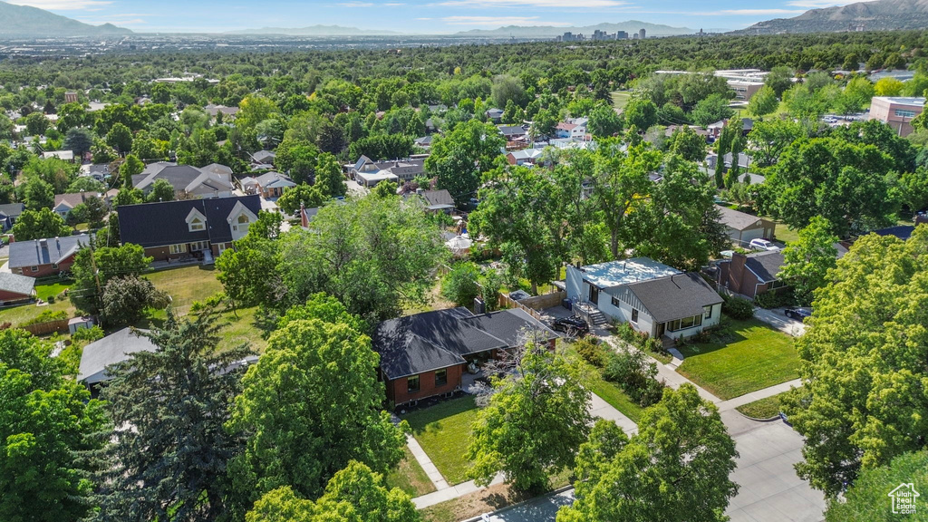 Aerial view of property's location with nearby suburban area and a mountainous background