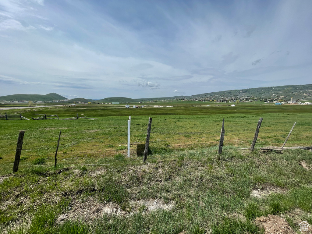 View of gate featuring fence and a rural view