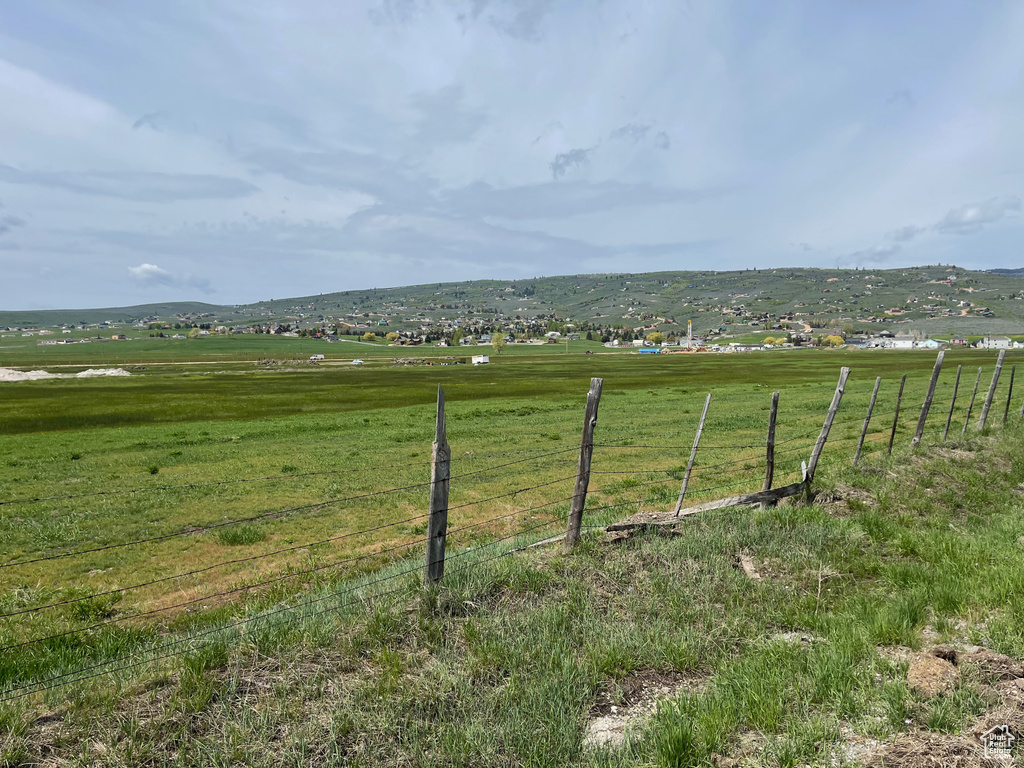 View of yard featuring fence and a rural view