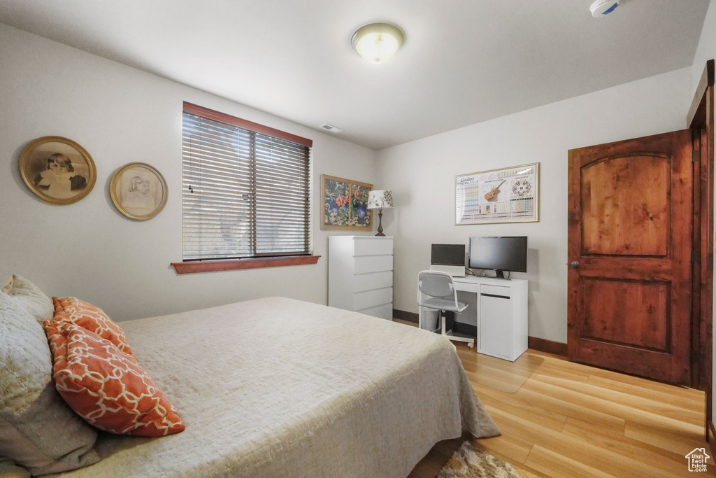 Bedroom with baseboards and light wood-type flooring