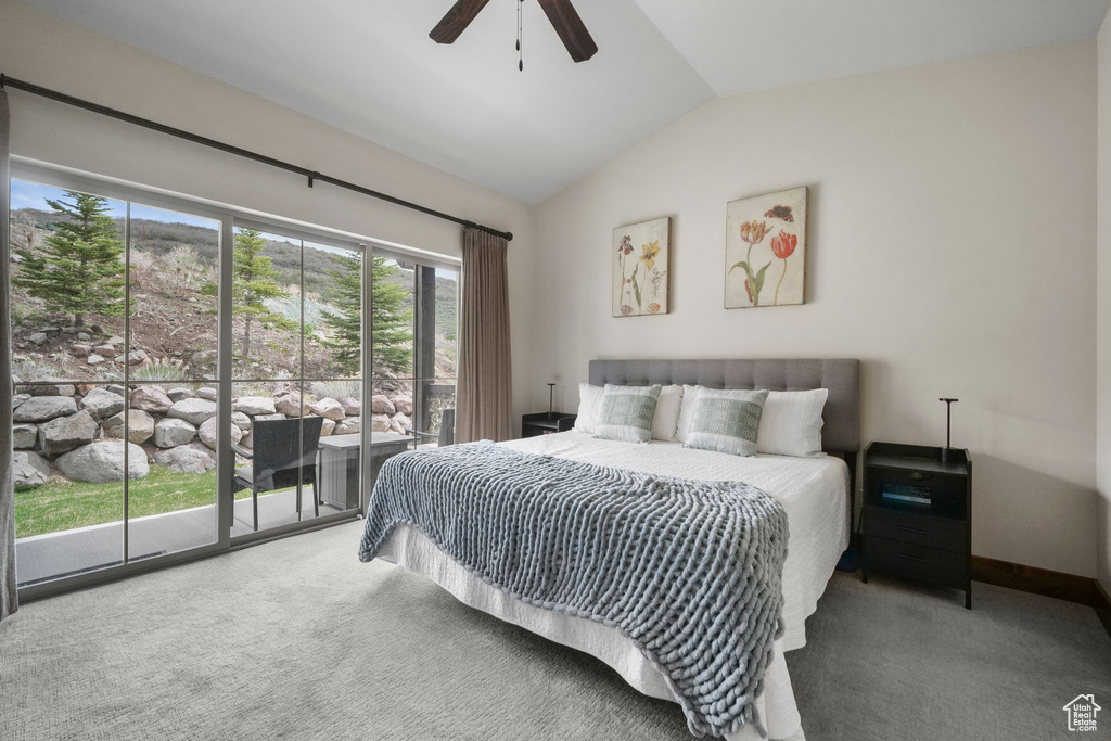 Bedroom featuring a ceiling fan, carpet flooring, access to outside, and vaulted ceiling