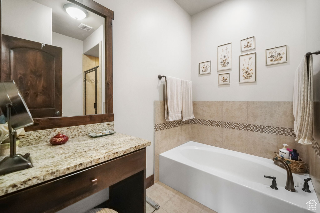 Full bathroom featuring vanity, visible vents, tile patterned flooring, a shower stall, and a bath