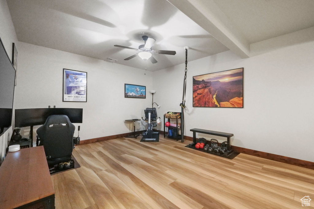Office space with a ceiling fan, baseboards, and wood finished floors