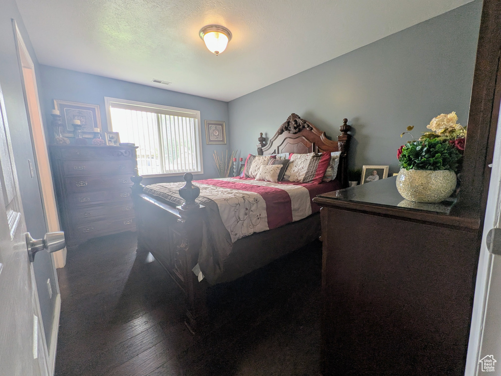 Bedroom with visible vents and wood-type flooring