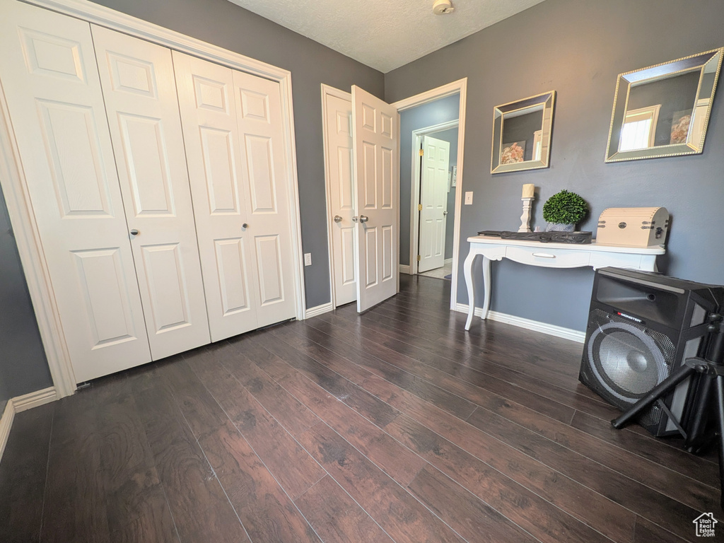 Entrance foyer featuring baseboards and dark wood-style flooring