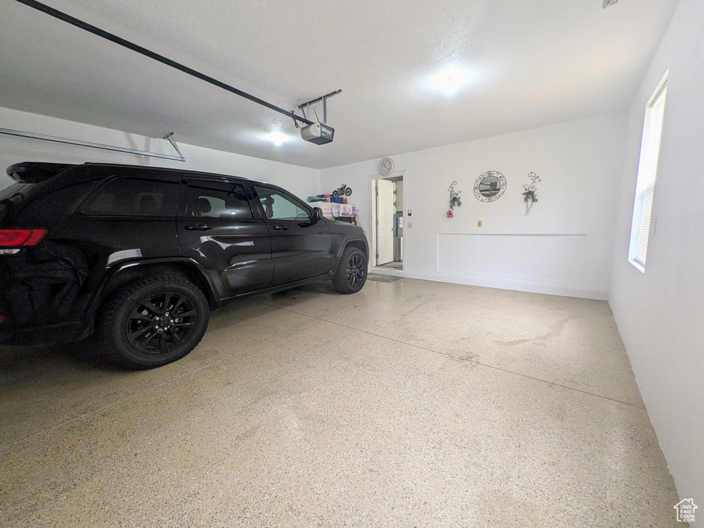 Garage featuring a garage door opener