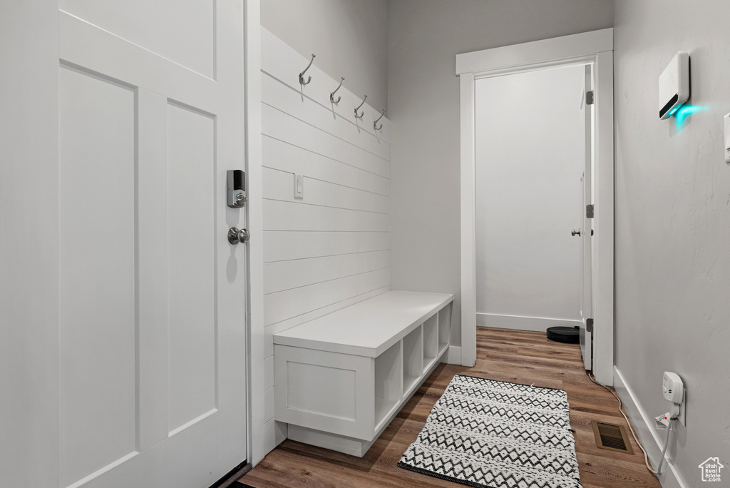 Mudroom with baseboards, visible vents, and wood finished floors