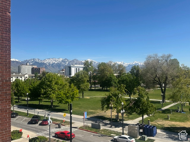 Surrounding community with uncovered parking and a mountain view