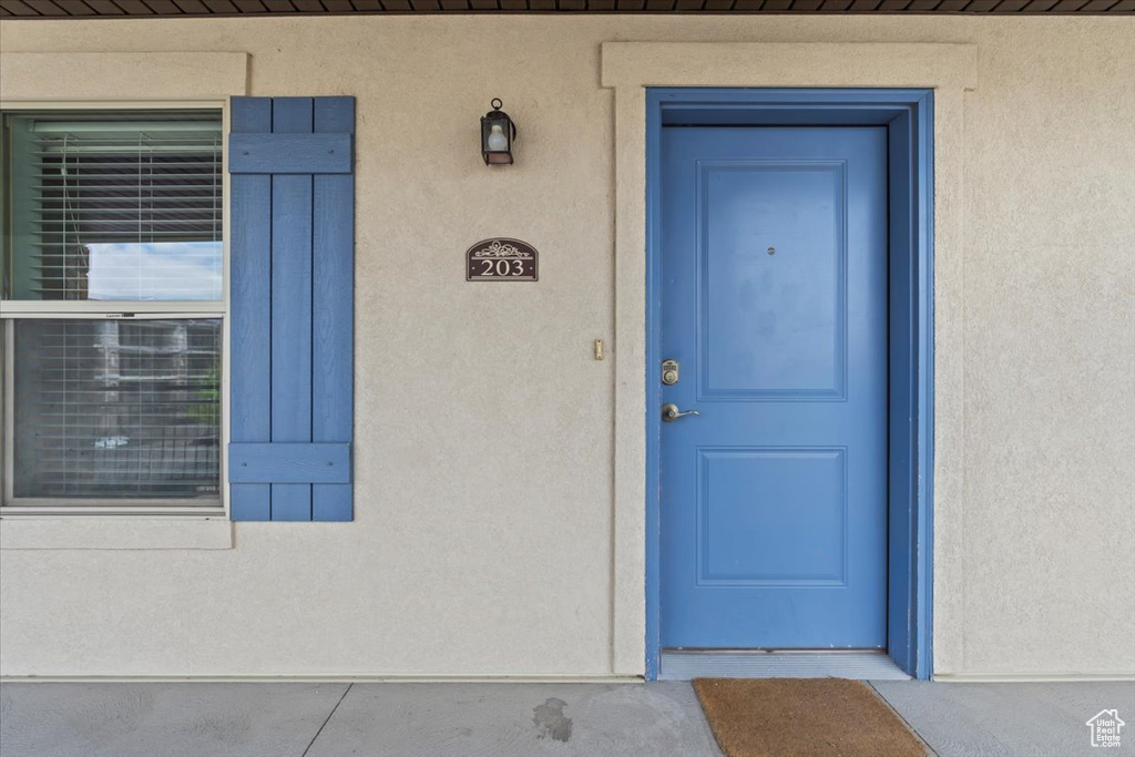 Entrance to property with stucco siding