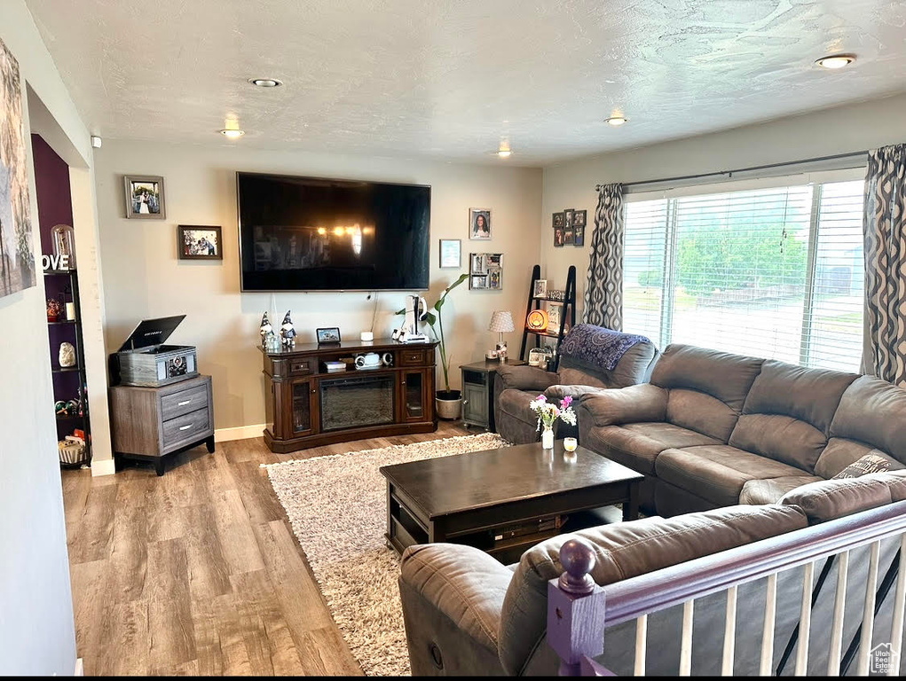 Living area with light wood finished floors and baseboards