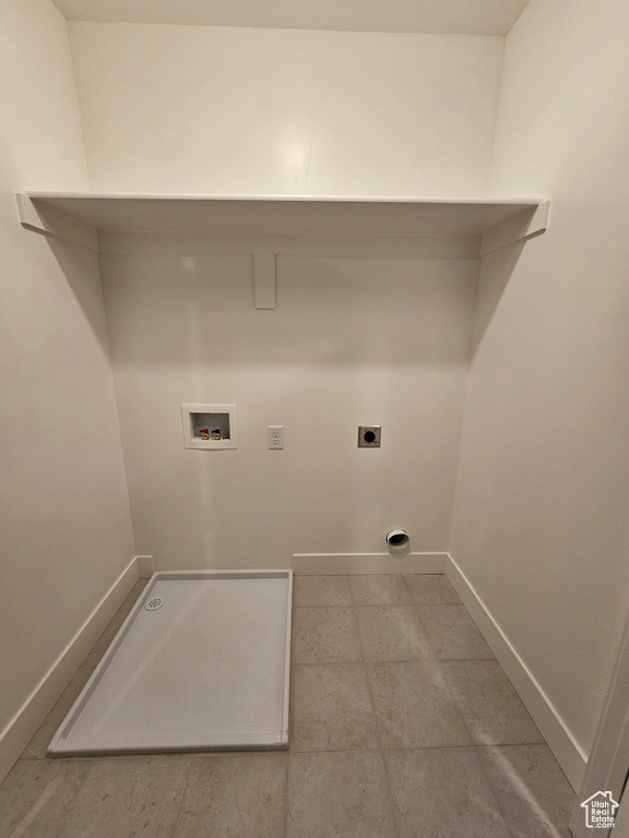 Laundry room featuring laundry area, hookup for an electric dryer, washer hookup, and baseboards