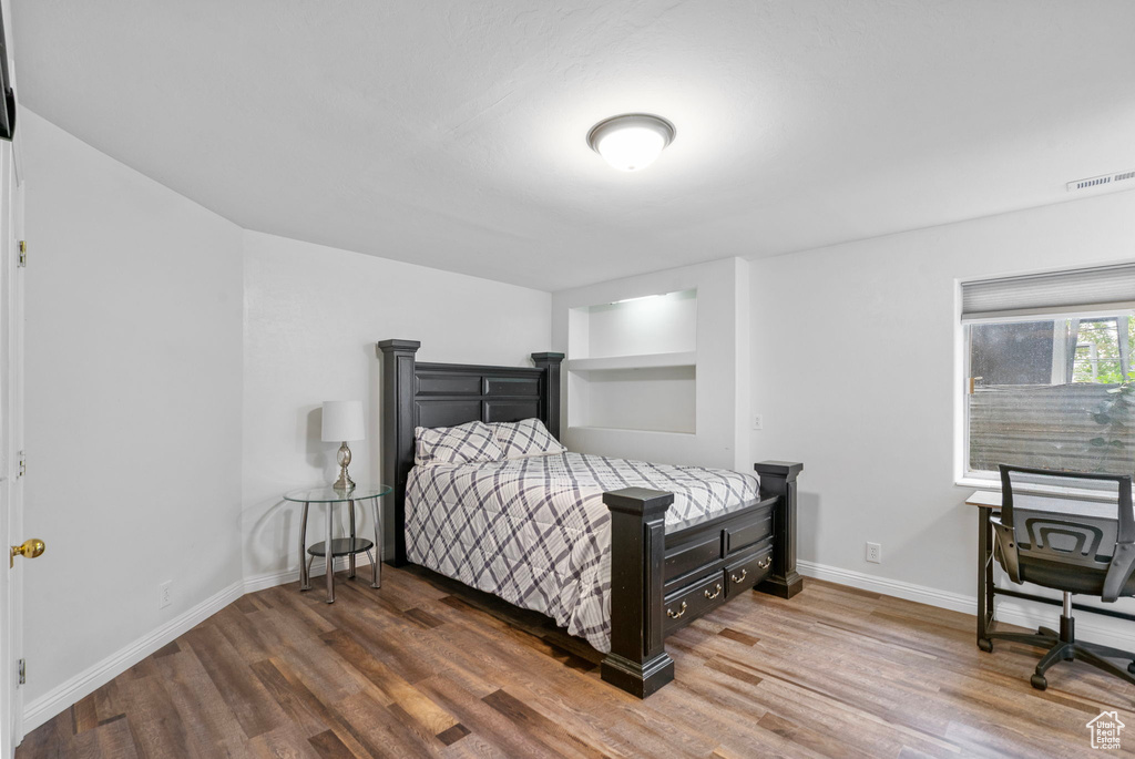 Bedroom featuring visible vents, wood finished floors, and baseboards