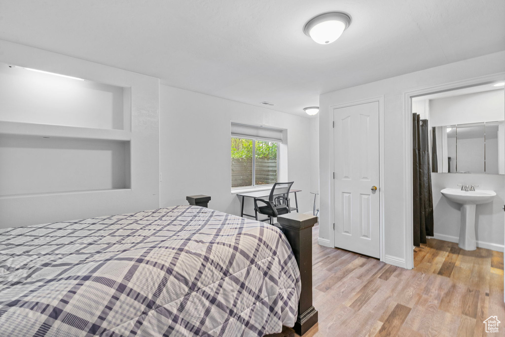 Bedroom featuring baseboards and wood finished floors