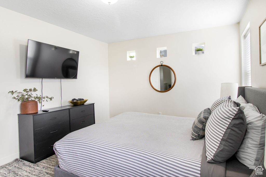 Bedroom featuring light colored carpet
