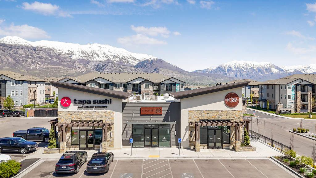View of property featuring uncovered parking and a mountain view