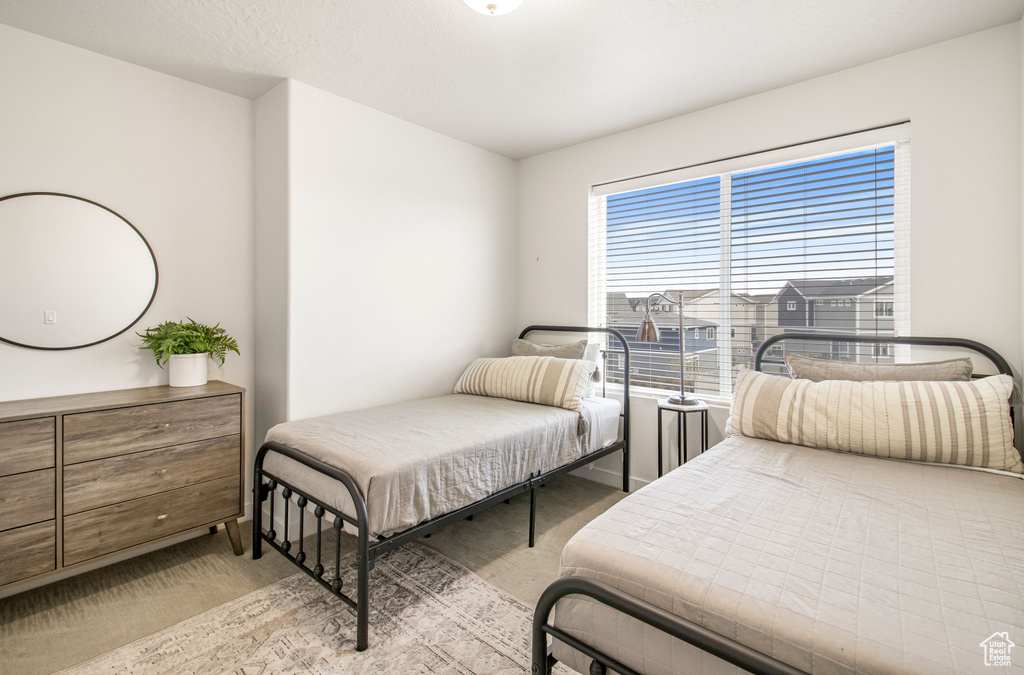 Bedroom with light carpet