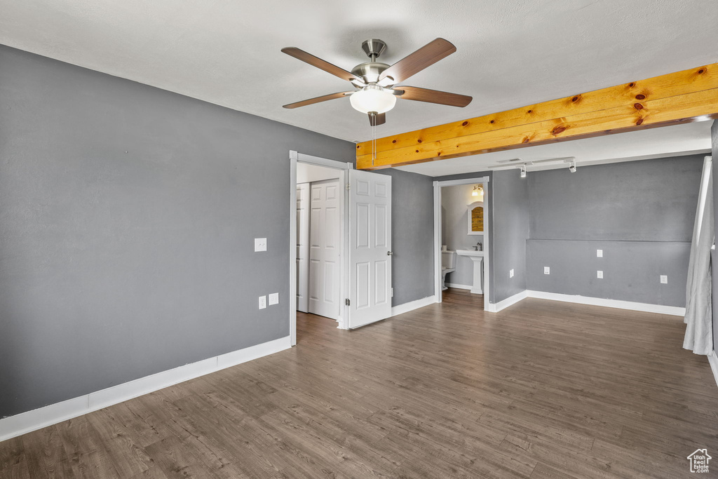 Spare room featuring ceiling fan, baseboards, and wood finished floors