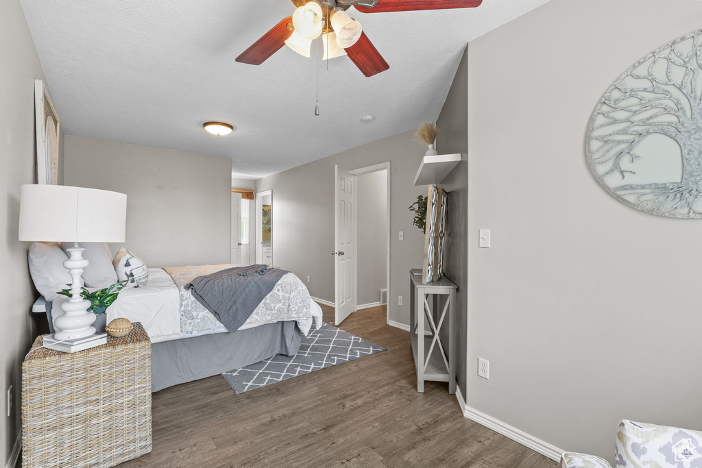 Bedroom with wood finished floors, baseboards, and ceiling fan
