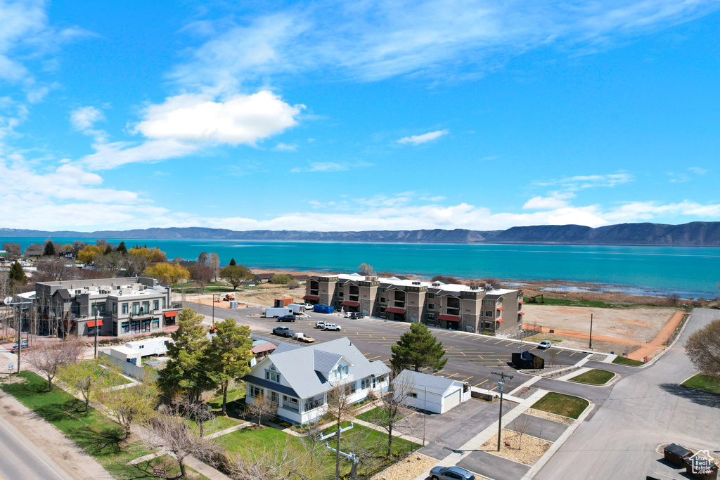 Drone / aerial view featuring a water and mountain view