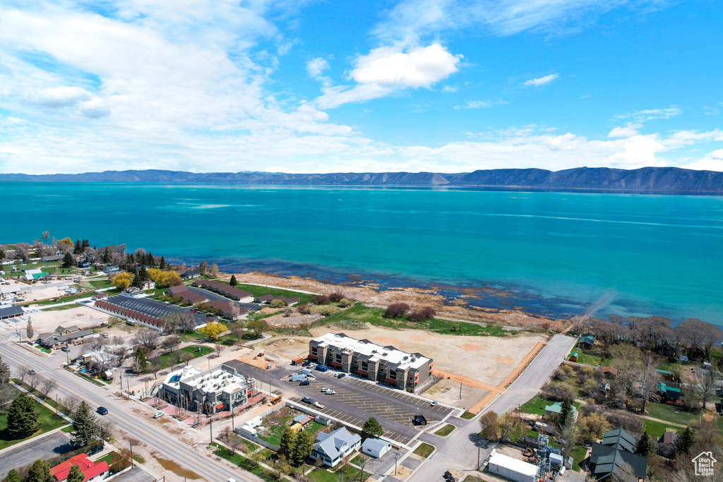 Birds eye view of property featuring a water and mountain view