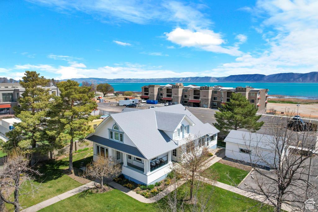 Birds eye view of property with a water and mountain view