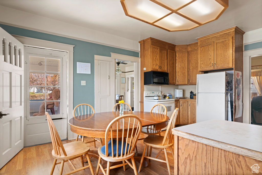 Dining area with light wood finished floors and ceiling fan