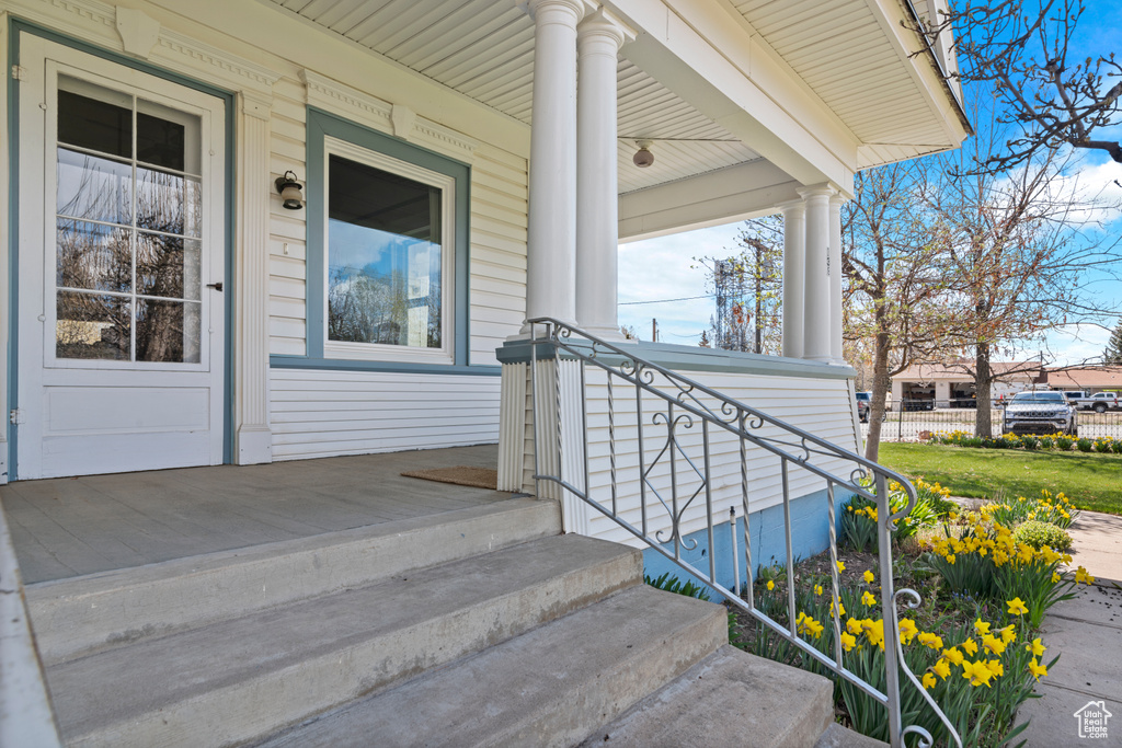 Entrance to property featuring covered porch