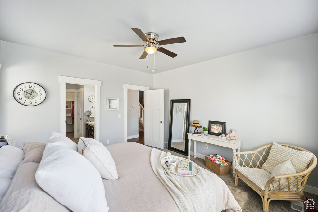 Bedroom featuring ensuite bath, baseboards, and a ceiling fan