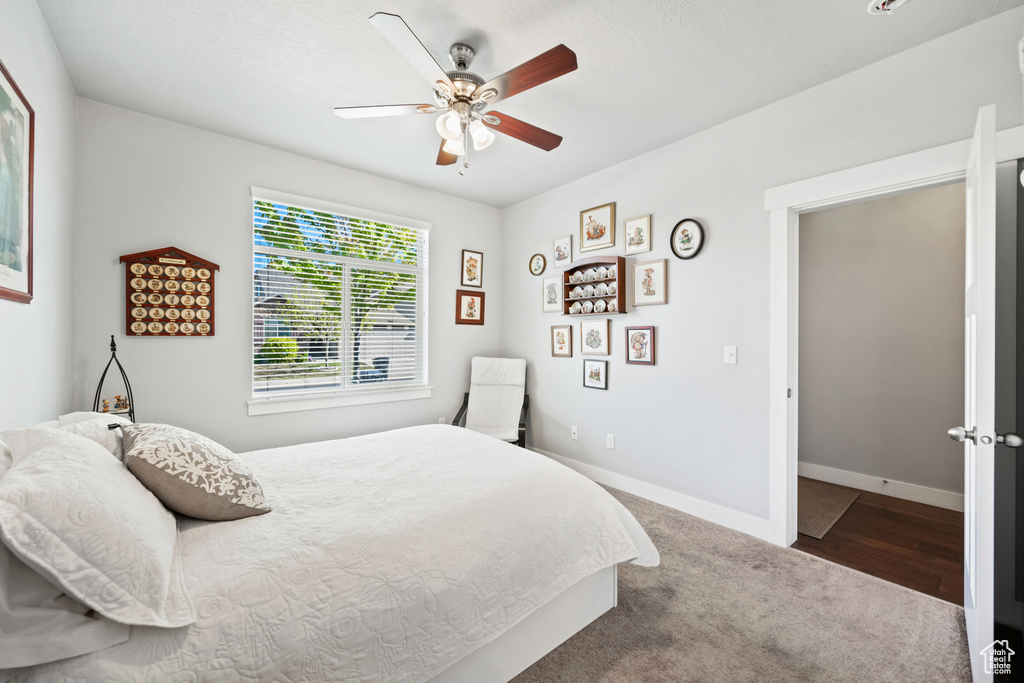 Bedroom featuring carpet flooring, baseboards, and a ceiling fan
