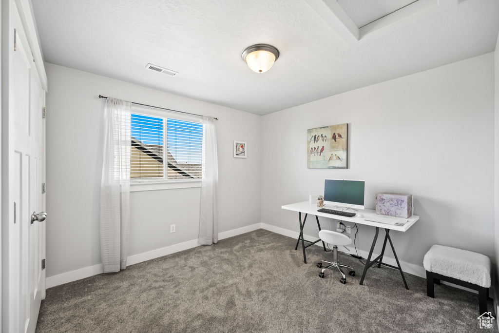 Office space featuring baseboards, visible vents, and carpet floors